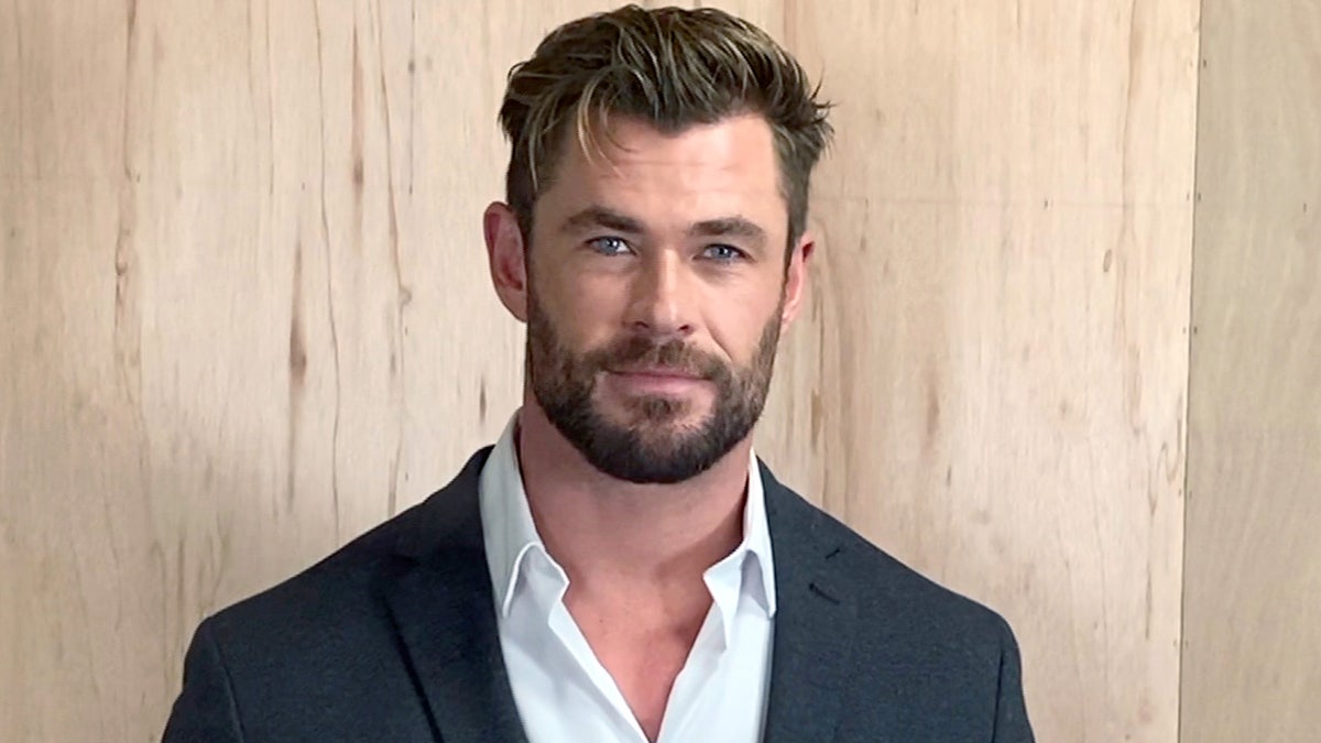 Chris Hemsworth posa para una sesión de fotos con traje de chaqueta y camisa abotonada