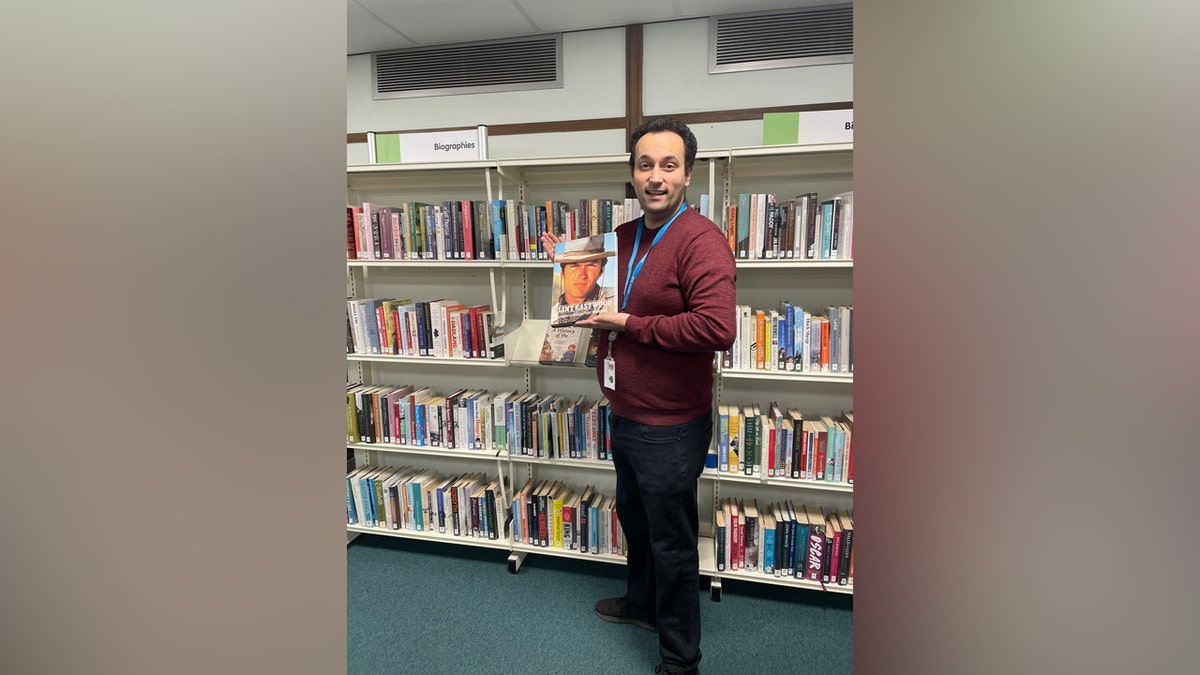 Un gran bibliotecario sosteniendo un libro perdido hace mucho tiempo