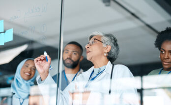 Healthcare, glass and woman writing, staff and brainstorming for procedure, diagnosis and research. Medical professionals, leader and teamwork to share ideas, medicine development and conversation
