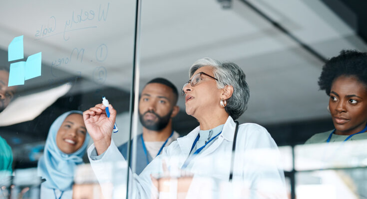 Healthcare, glass and woman writing, staff and brainstorming for procedure, diagnosis and research. Medical professionals, leader and teamwork to share ideas, medicine development and conversation