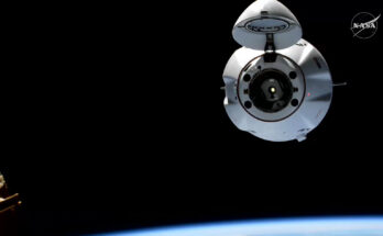The SpaceX Dragon cargo spaceraft, with its nosecone open, approaches the International Space Station for an automated docking.