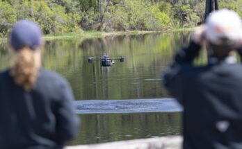 a drone flying low over a body of water