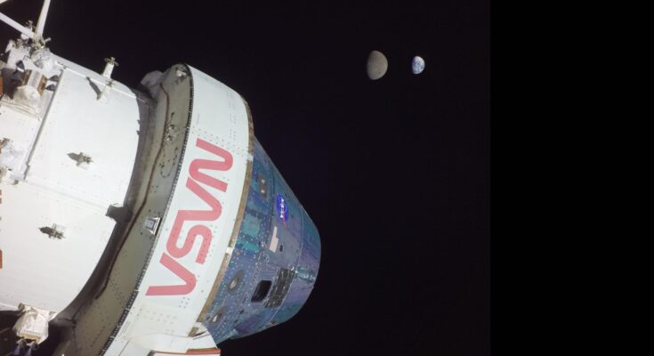 A large white space shuttle labeled in red "NASA" is seen in the darkness of space.