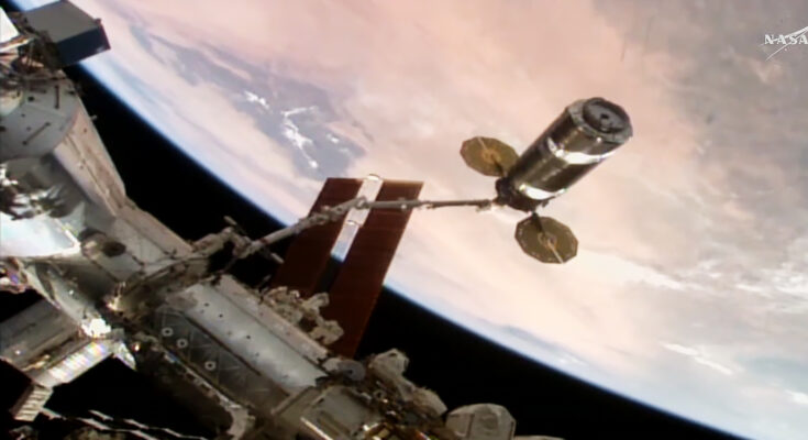 The Cygnus XL cargo craft is maneuvered by the Canadarm2 robotic arm toward the International Space Station's Unity module for installation.