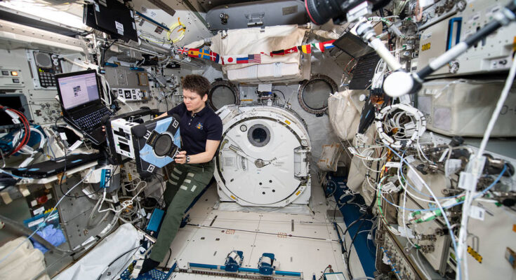 NASA astronaut Anne McClain performs the first series of tests of an Astrobee robot, Bumble, during a hardware checkout.