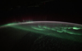 The aurora australis appears to lap over the Earth like a tide washing ashore in this photograph taken at approximately 3:45 a.m. local time from the International Space Station as it orbited 269 miles above the Indian Ocean southwest of Australia.