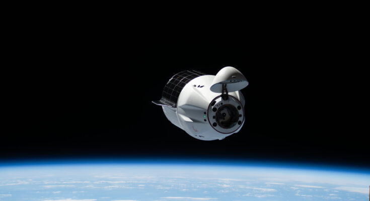 A SpaceX Dragon cargo spacecraft with its nosecone open and carrying over 5,000 pounds of science, supplies, and hardware for NASA's SpaceX CRS-33 mission approaches the International Space Station for an automated docking to the Harmony module's forward port. Both spacecraft were flying 262 miles above the Atlantic Ocean east of the Canadian province of Newfoundland at the time of this photograph.