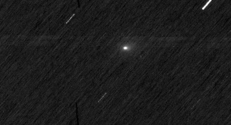 a bright white orb on a black, streaky background