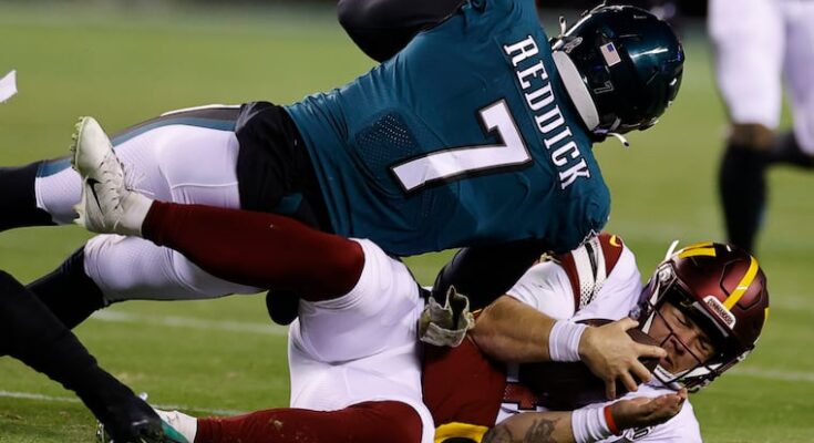 Washington Commanders quarterback Taylor Heinicke is tackled by former Eagles linebacker Haason Reddick at Lincoln Financial Field in 2022.