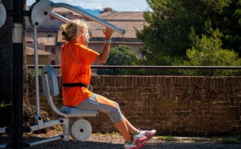 A woman uses outdoor gym equipment